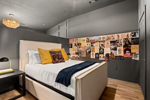 Bedroom- queen bed with 2 night tables on both sides along with lamps, and a gallery wall to admire!!