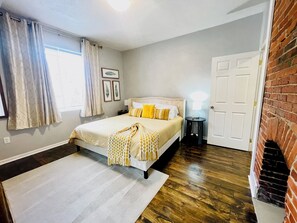 Lower floor king bedroom with 12 inch memory foam mattress. Exposed brick adds charm.