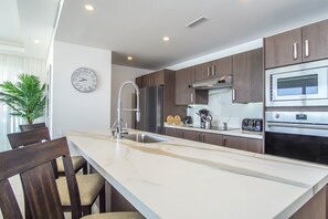 long counter top makes the kitchen even more welcoming.