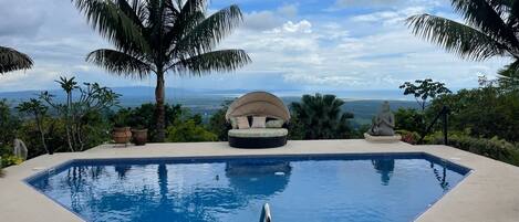 Large private pool with sweeping 180 degree ocean views, mountain views and a large patio area. 