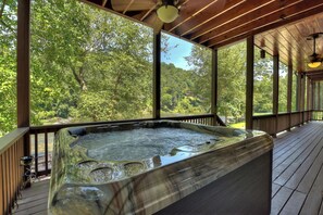 Relax in the hot tub as you enjoy the view of the Coosawattee River