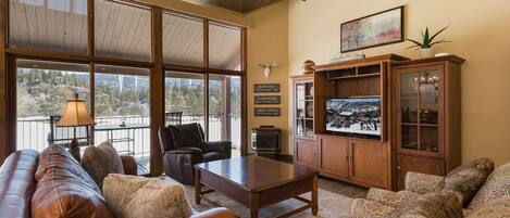 Living Room with Ample Seating, Large Windows for Natural Light, Fireplace and TV