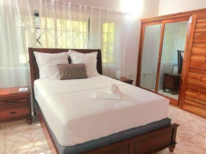 second bedroom with a comfortable queensize bed and a large wardrobe 