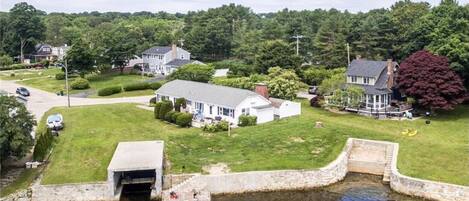 Waterfront home with dock, boat garage, and beach