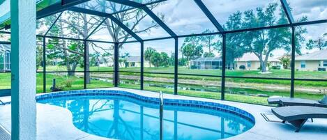 Elegant pool deck offering panoramic views of the waterway