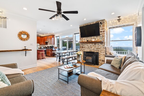 Living room, stone fireplace and Bose surround sound. Pull out couch on right. 