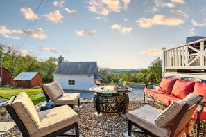 Gas fire pit in river rock patio, front of house, west-facing 
