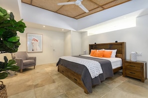 The primary bedroom boasts high-ceilings and a king bed.