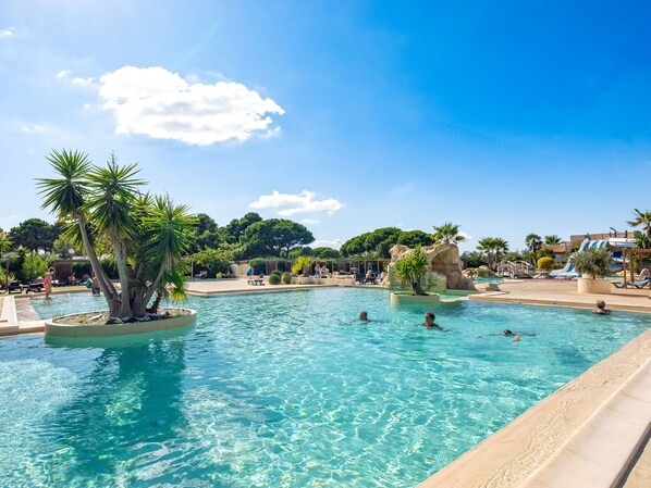 Tropical-style pool surrounded by palm trees, offering a refreshing oasis.