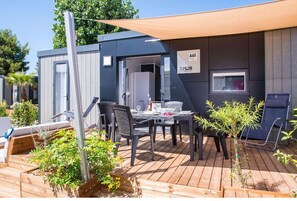 Modern camping home with a private deck, perfect for outdoor dining and relaxation.