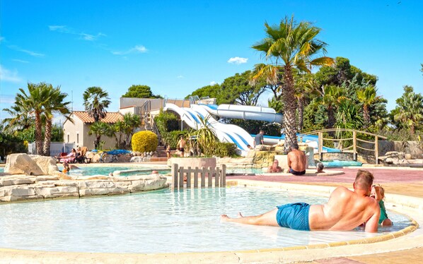 Relaxing poolside area with tropical scenery, ideal for unwinding in the sun.