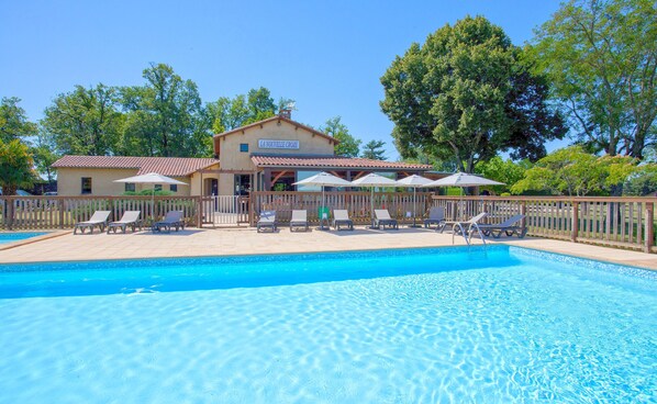 A serene pool with lush surroundings.