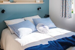 A bedroom with seaside decor touches.