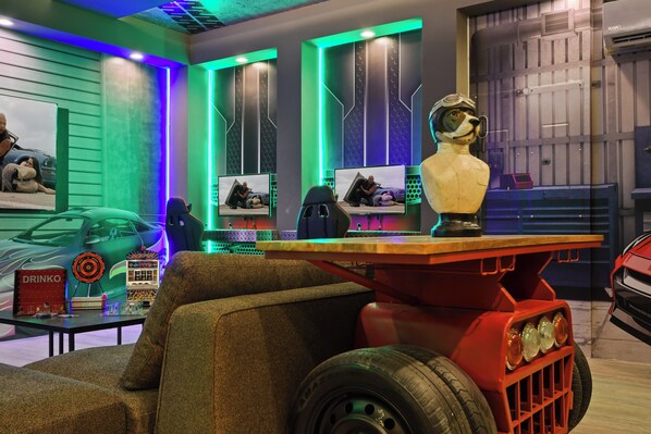 Race car gamer’s paradise with neon vibes, movie nights, and unique decor
