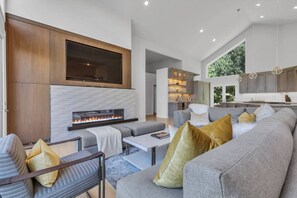 Watch the Game and enjoy the Comfort of this Stylishly Designed Great Room with Faux Fireplace that changes Accent Colors According to your Mood