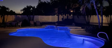 View of the lighted pool at night. Private backyard will allow you to use the pool at all times and feel like you are not surrounded by others. 
