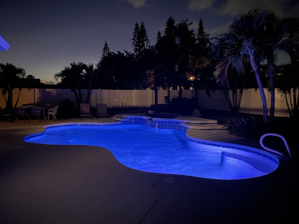 View of the lighted pool at night. Private backyard will allow you to use the pool at all times and feel like you are not surrounded by others. 