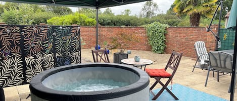 South facing walled courtyard with covered Spa Pool and outdoor dining