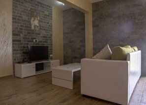 Modern furnished living room with flat TV screen and free WiFi