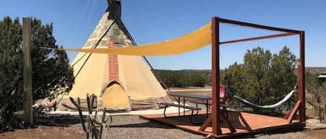 Unique TIPI features private outside sitting space and is located about 50ft from the shared luxury bathhouse. 