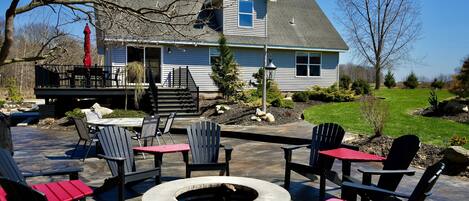 Spacious backyard with fire pit, play equipment, and plenty of lawn. 