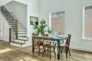 Set the table for memorable meals in this beautifully arranged dining area. With elegant place settings and a charming centerpiece, it's perfect for hosting dinner parties or enjoying family dinners in a cozy and stylish atmosphere.
