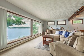 Spacious living room with large picture windows overlooking Keuka Lake. 