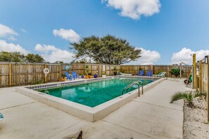 Community pool with lounge chairs for ultimate relaxation.