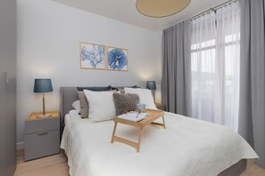 A peaceful bedroom with a large bed, soft linens, and neutral decor for a relaxing atmosphere.