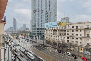 A vibrant urban view with a bustling street and modern architecture.