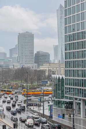 A cityscape view featuring a high-rise building on a foggy day.
