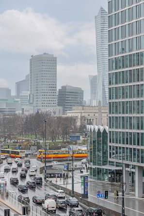 A cityscape view featuring a high-rise building on a foggy day.