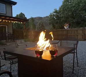 Relax with your glass of wine at the propane fire pit table. 