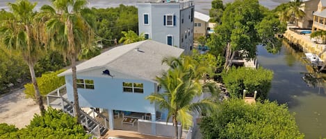 Aerial views of the home, street, canal and pool: PELICANS NEST