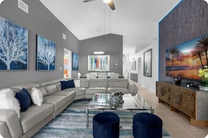 Clean, modern, genuine leather living room with 70" Roku TV