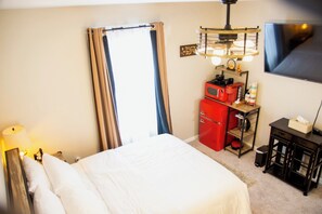 Reversible ceiling fan and full size window with blackout curtains.
