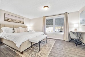 Master bedroom with king size bed and 2 workspaces