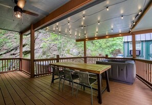 Back deck with dining table and hot tub. A grill was added later.