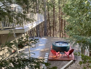 View of the backyard and deck above, from the trees surrounding the chalet.