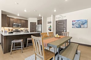 The fully equipped kitchen is a gorgeous area with spacious counters and a kitchen bar connecting the space to the dining room.