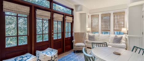 Living room with gorgeous natural light. Side doors lead to private porch with outdoor dining for 2