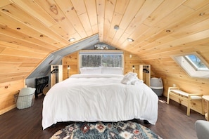 Up our spiral staircase in the loft, you'll find a King-size bed, hanging rod for clothes and nearby bathroom.