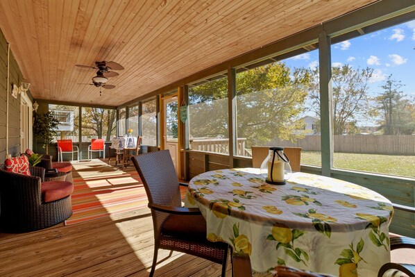 Spacious enough for everyone, this screened-in porch is the perfect spot to share laughter, stories, and good food while staying sheltered from the elements.