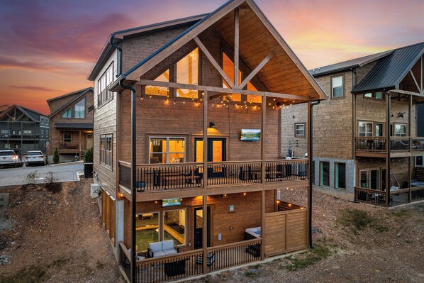 Back of Cabin includes 2 decks, hot tub, grill, 2 TVs, dining tables, and more
