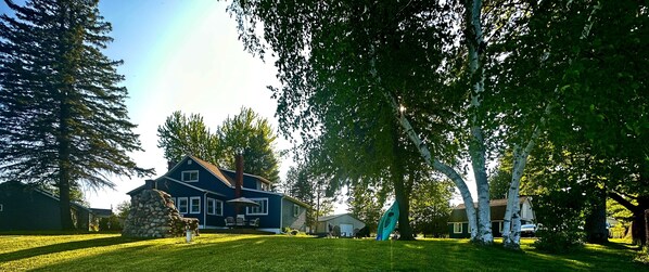 Yard w/ fire pit, outdoor games,  patio set,  rocking chairs, grill, volleyball