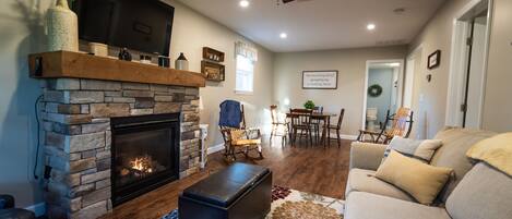 The Living Room features a gas fireplace and a 49" TV to stream your shows.