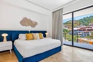 [Main Bedroom] Spacious king bed with hallway access and en-suite bathroom.