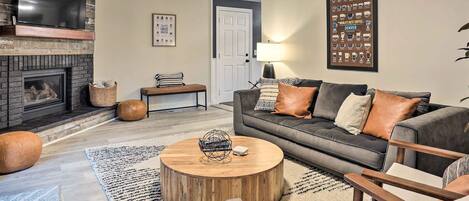 Experience coffee décor, comfy seating + fireplace as you enter the living room