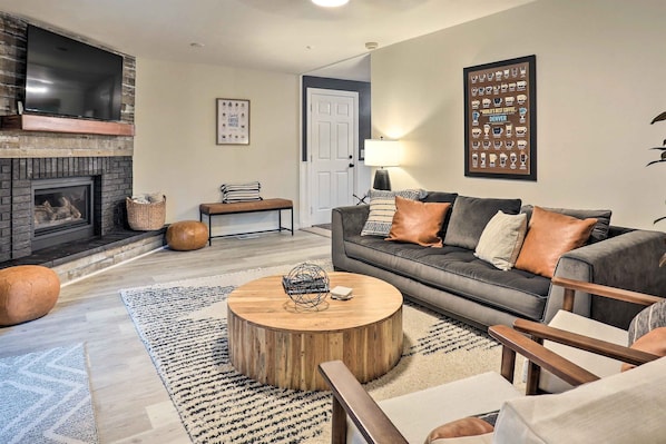 Experience coffee décor, comfy seating + fireplace as you enter the living room