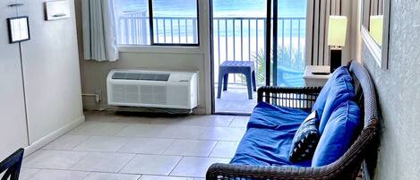 Living room with a balcony and beach front view.